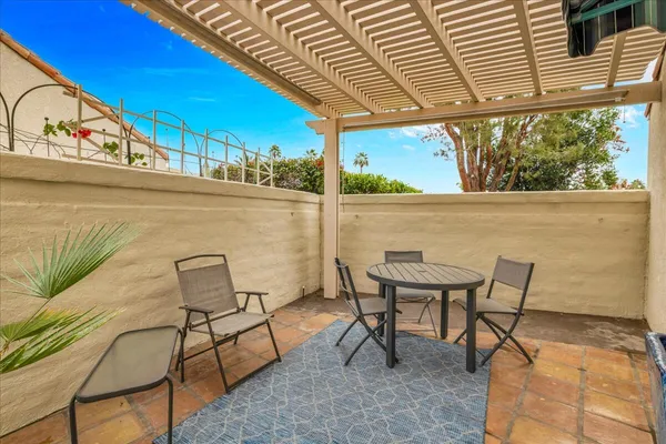 a view of a chairs and table in the balcony