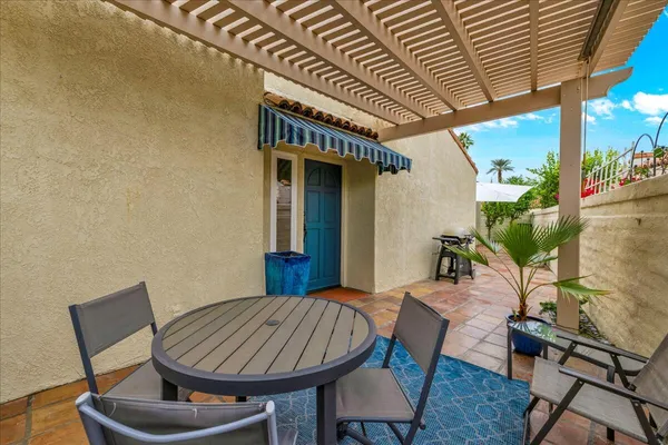 a view of a patio with table and chairs