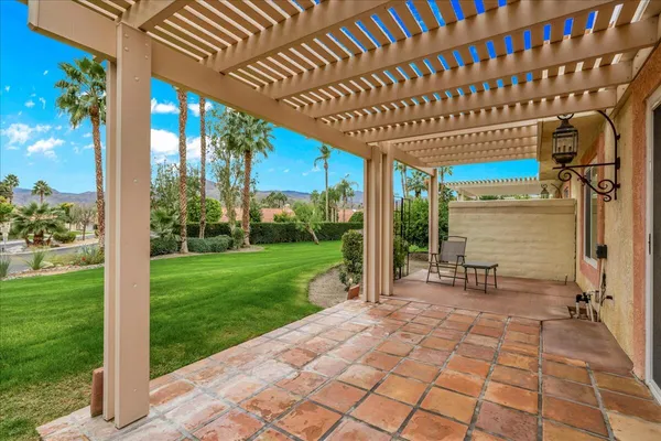 a view of a porch with chairs and backyard