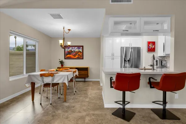 a dining room with furniture and window