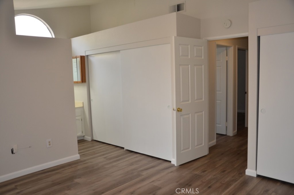 29620 Nightcrest Circle Temecula, CA 92591 - Photo 23 of 31 a view of an empty room with wooden floor and a window