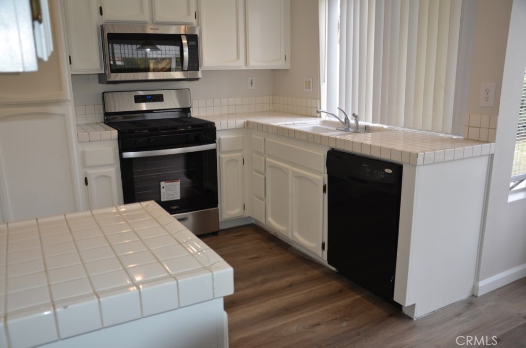 29620 Nightcrest Circle Temecula, CA 92591 - Photo 9 of 31 a kitchen with stainless steel appliances a stove microwave and a sink