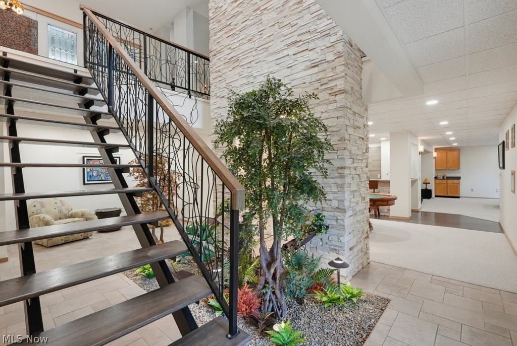 1758 Meander Way Mogadore, OH 44260 - Photo 36 of 50 Lower Entrance Foyer with Fountain and Artificial Plants