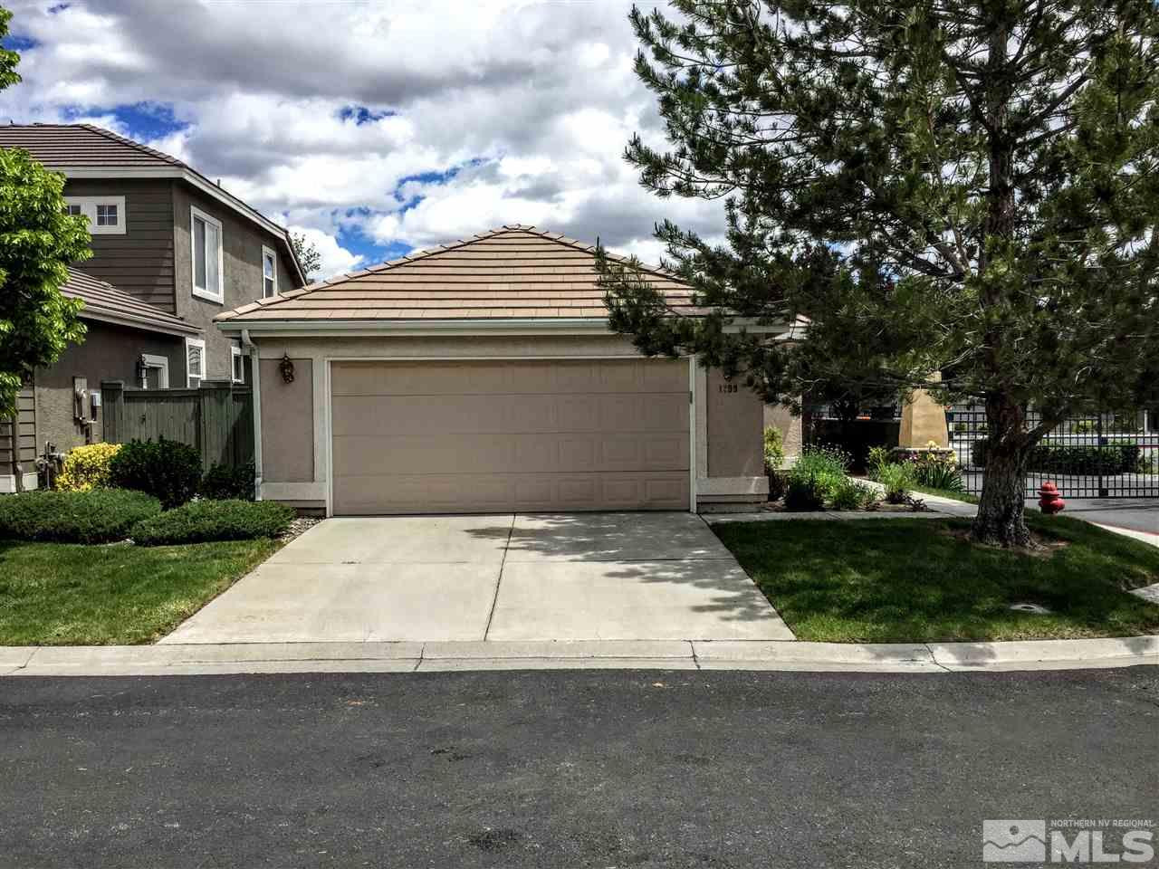 1299 Tule Drive Reno, NV 89521 - Photo 1 of 1 a front view of a house with a yard and garage