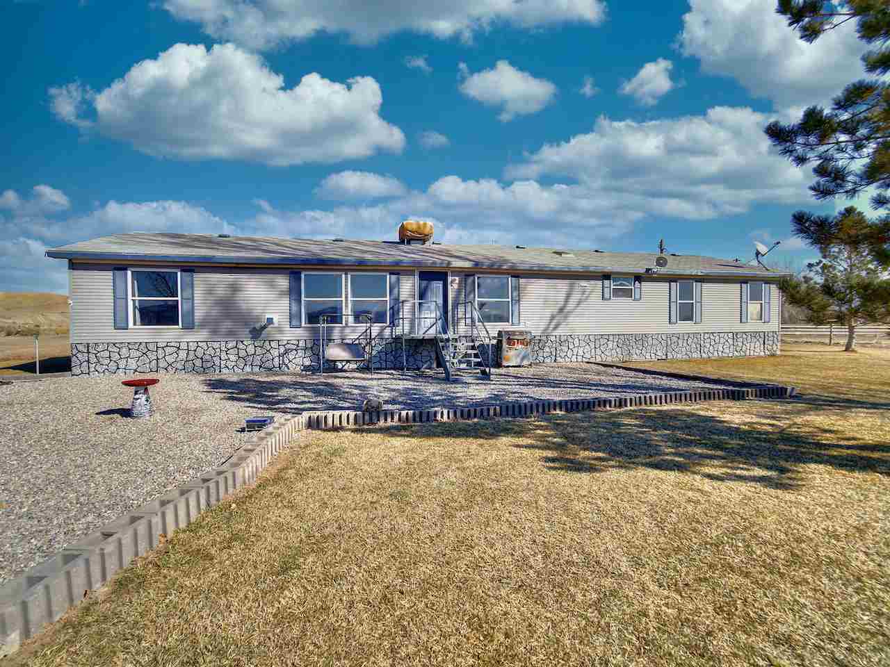 1675 North 1/2 Road Fruita, CO 81521 - Photo 1 of 31 a view of a house with swimming pool and sitting area