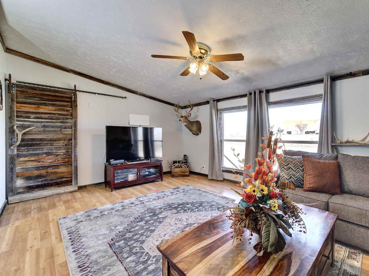 1675 North 1/2 Road Fruita, CO 81521 - Photo 11 of 31 a living room with furniture and a flat screen tv