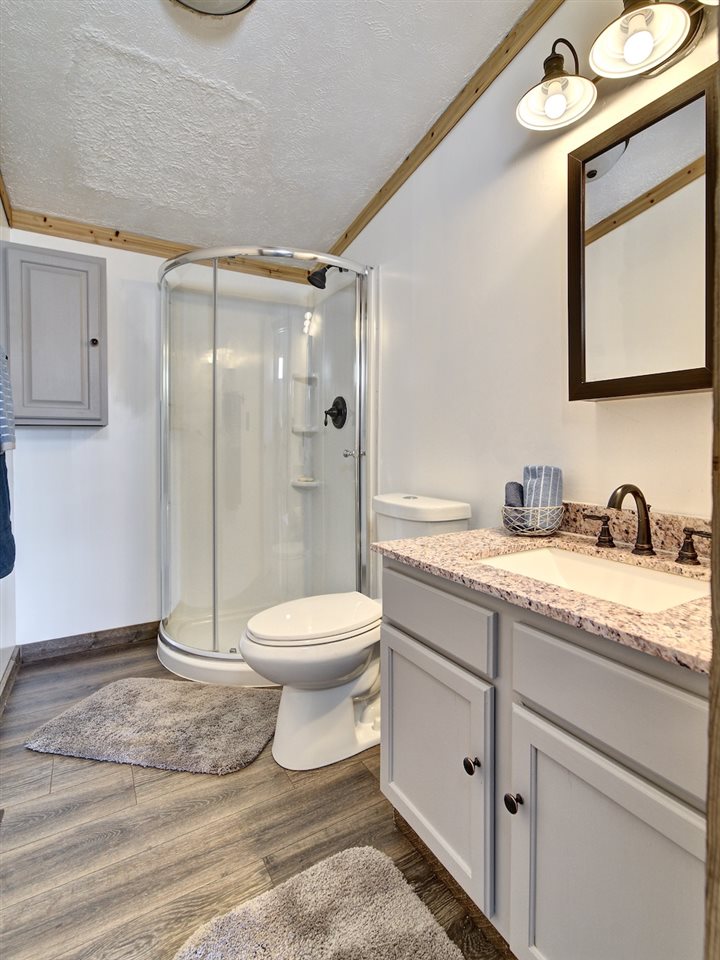 1675 North 1/2 Road Fruita, CO 81521 - Photo 17 of 31 a bathroom with a granite countertop sink toilet and shower
