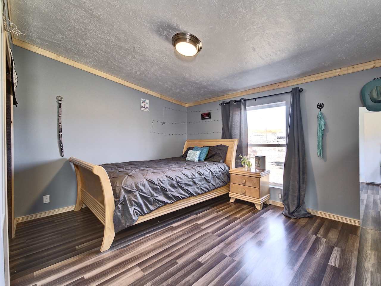 1675 North 1/2 Road Fruita, CO 81521 - Photo 19 of 31 a bedroom with a bed and wooden floor
