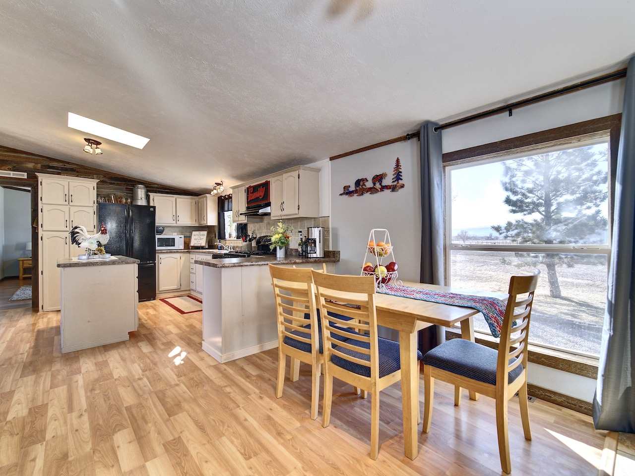 1675 North 1/2 Road Fruita, CO 81521 - Photo 2 of 31 a dining room with furniture and wooden floor