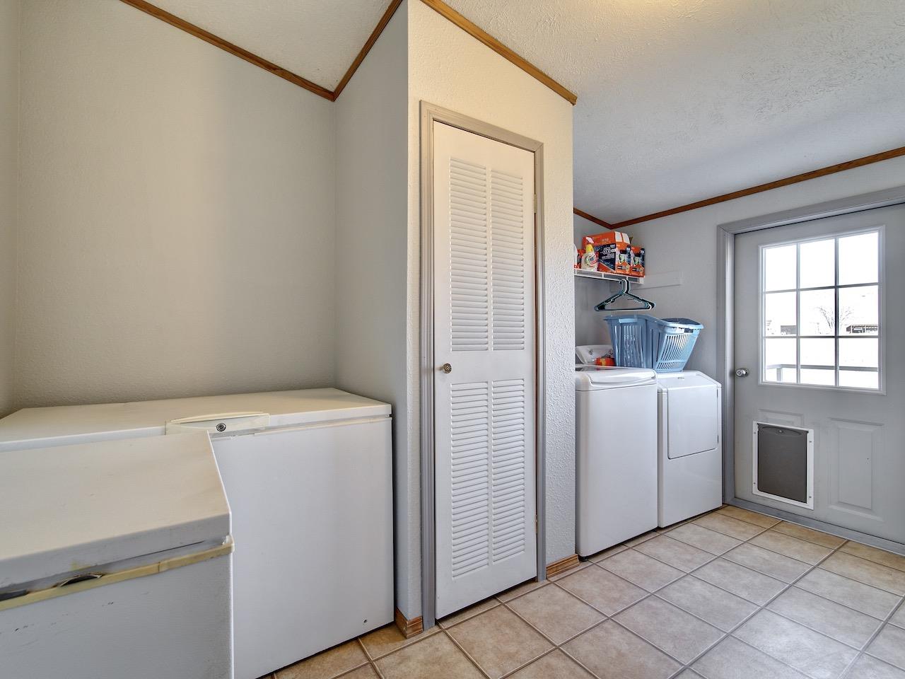 1675 North 1/2 Road Fruita, CO 81521 - Photo 21 of 31 a view of storage and utility room with washer and dryer