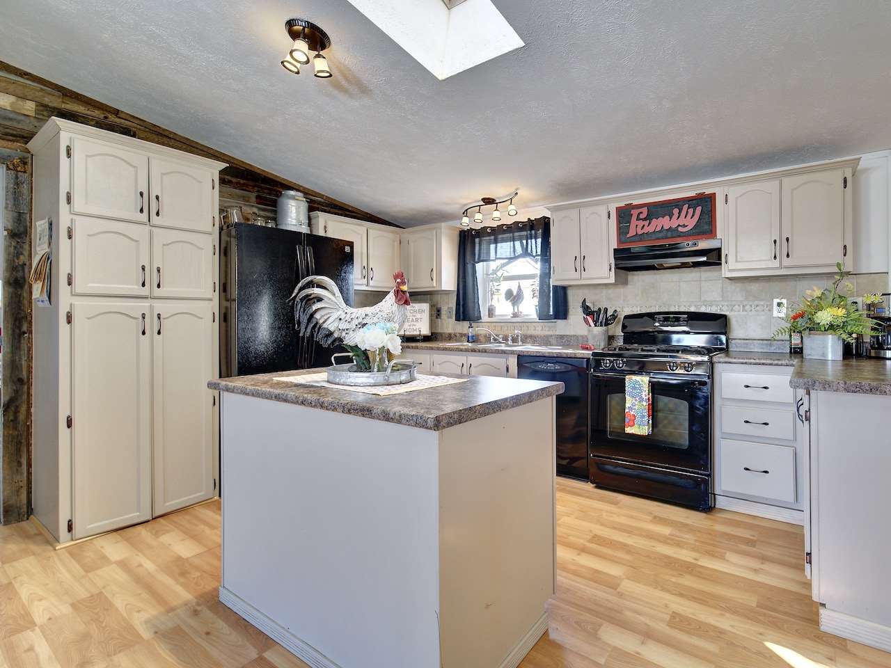 1675 North 1/2 Road Fruita, CO 81521 - Photo 4 of 31 a kitchen with granite countertop a sink cabinets stainless steel appliances and a window