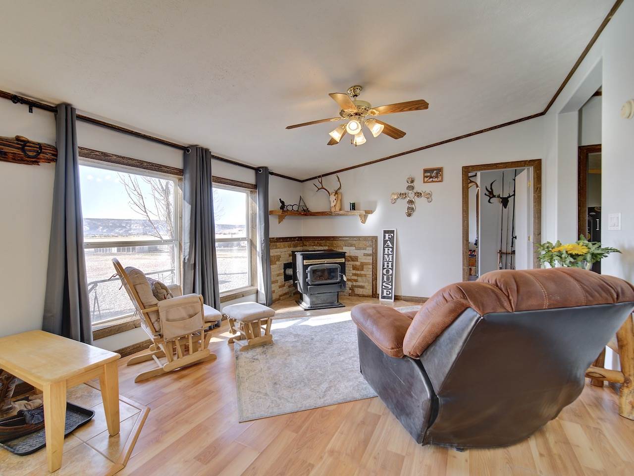 1675 North 1/2 Road Fruita, CO 81521 - Photo 8 of 31 a living room with furniture a fireplace and a large window
