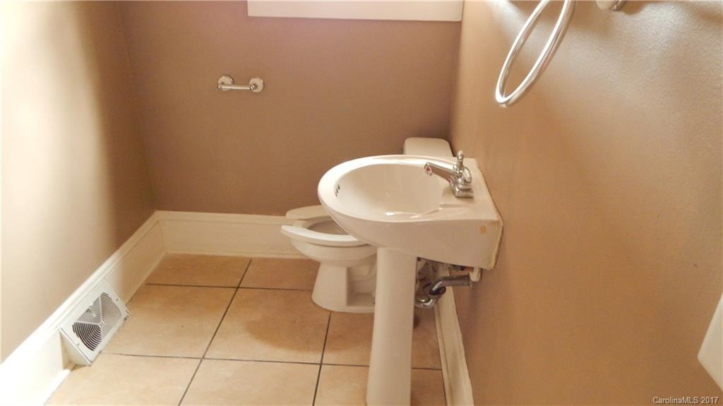 203 Charles Street, Unit A Monroe, NC 28112 - Photo 4 of 10 a bathroom with a sink toilet and a mirror