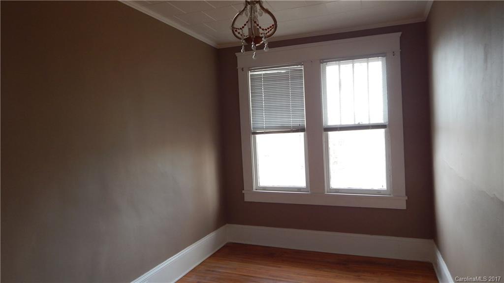203 Charles Street, Unit A Monroe, NC 28112 - Photo 10 of 10 a view of room with window and wooden floor