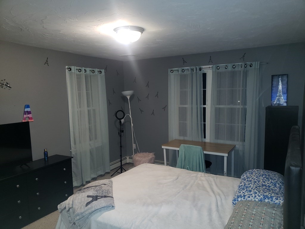 191 Holmes Road North Attleboro, MA 02760 - Photo 14 of 31 a bedroom with a bed and a flat tv screen on the dresser