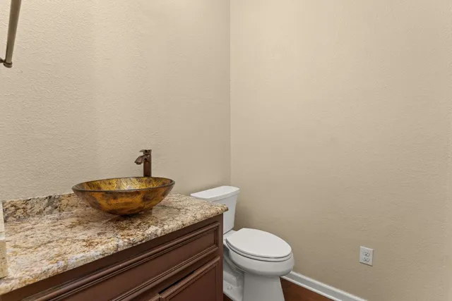 a bathroom with a granite countertop and sink