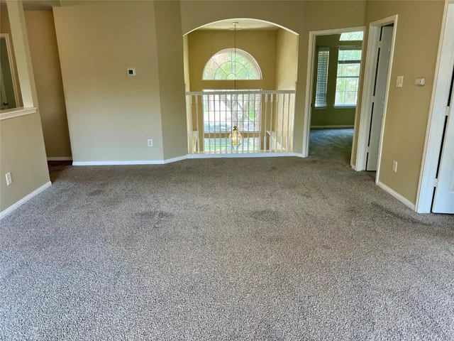 an empty room with windows dryer and a fireplace