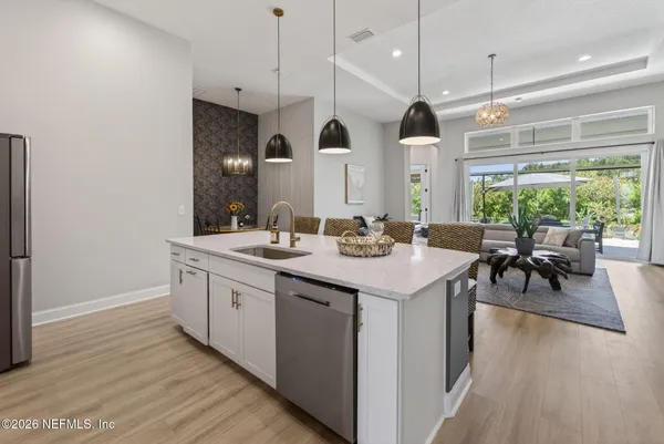 a kitchen with granite countertop white cabinets and stainless steel appliances
