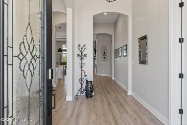 a kitchen with stainless steel appliances granite countertop a sink a stove a refrigerator and island with wooden floor
