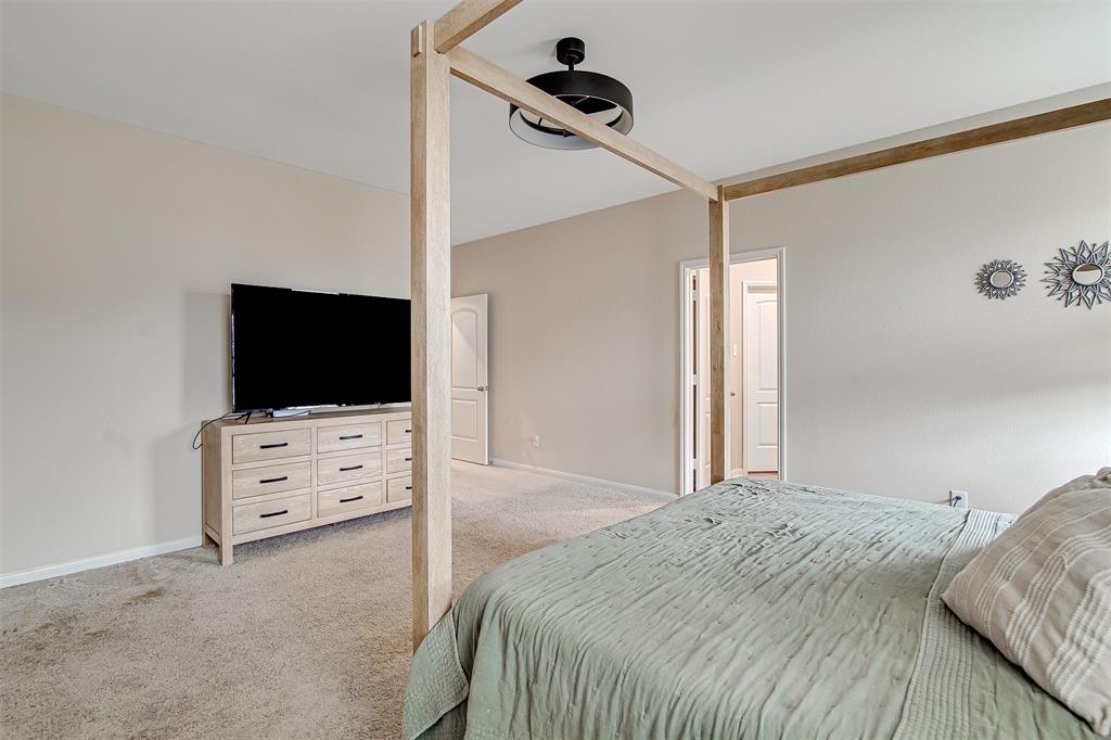 1813 Rialto Lane Crowley, TX 76036 - Photo 16 of 27 a bedroom with a bed and flat screen tv