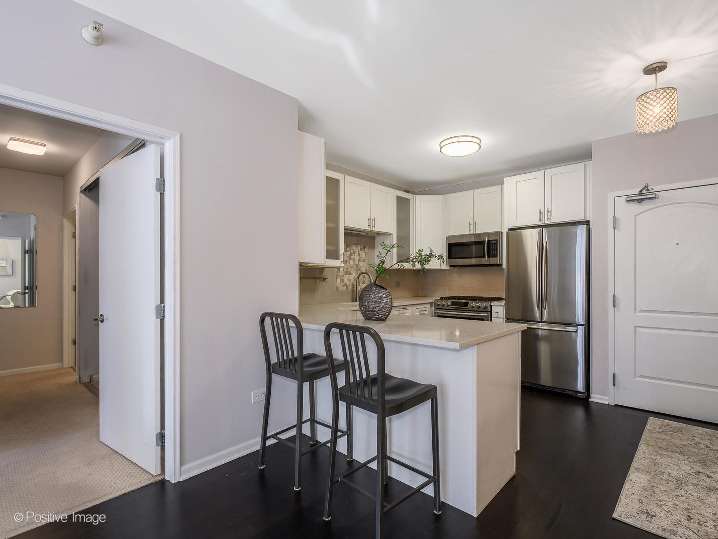 21 West Chestnut Street, Unit 1202 Chicago, IL 60654 - Photo 10 of 29 a kitchen with a refrigerator a stove top oven a sink and cabinets