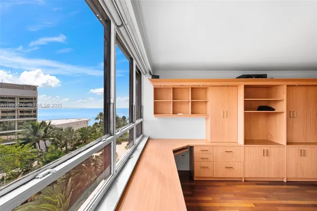 a view of balcony with floor to ceiling windows and wooden floor