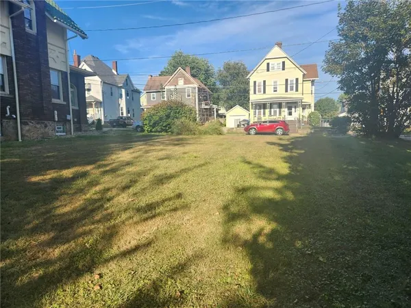 a view of a large house with pool and a yard