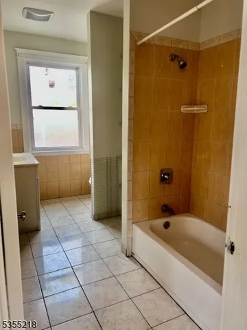 a bathroom with a bathtub and shower