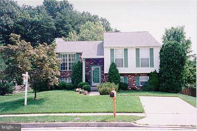 9009 Moonstone Road Nottingham, MD 21236 - Photo 1 of 1 a front view of a house with a yard