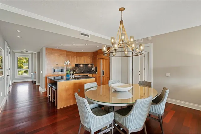 a view of a dining room with furniture wooden floor and chandelier