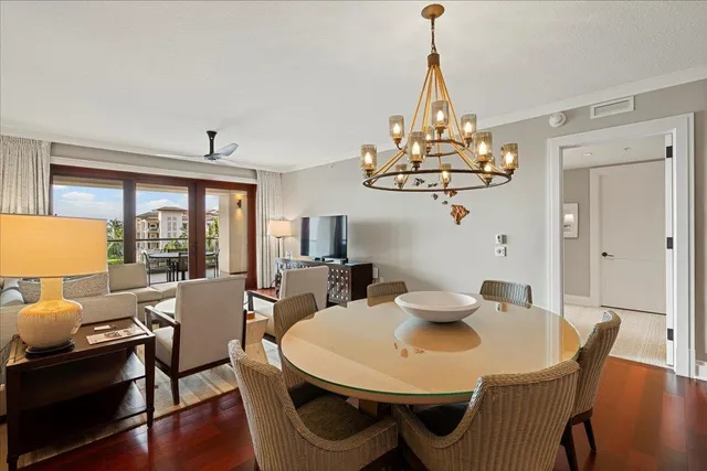 a view of a dining room with furniture wooden floor and chandelier