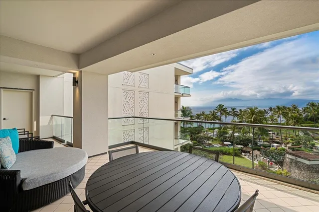 a view of a balcony with wooden floor and outdoor seating