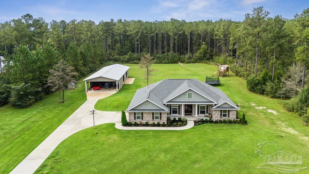 1571 Annie Penton Road Jay, FL 32565 - Photo 2 of 46 a aerial view of a house with a big yard and large trees