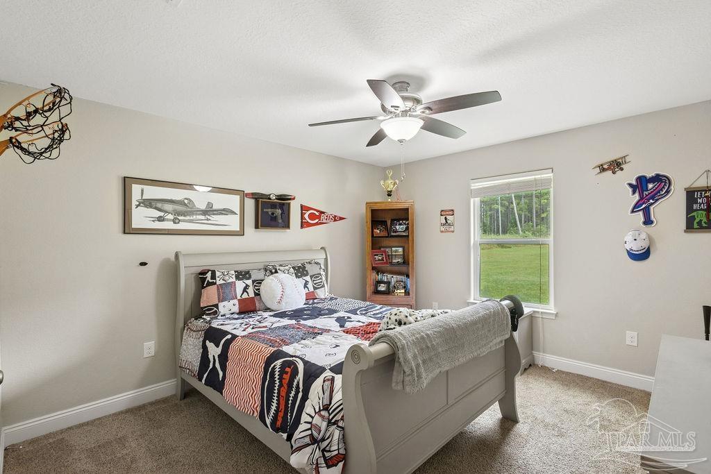 1571 Annie Penton Road Jay, FL 32565 - Photo 22 of 46 a bedroom with a bed and a window
