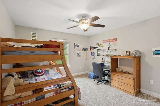 a bathroom with a granite countertop tub sink and mirror