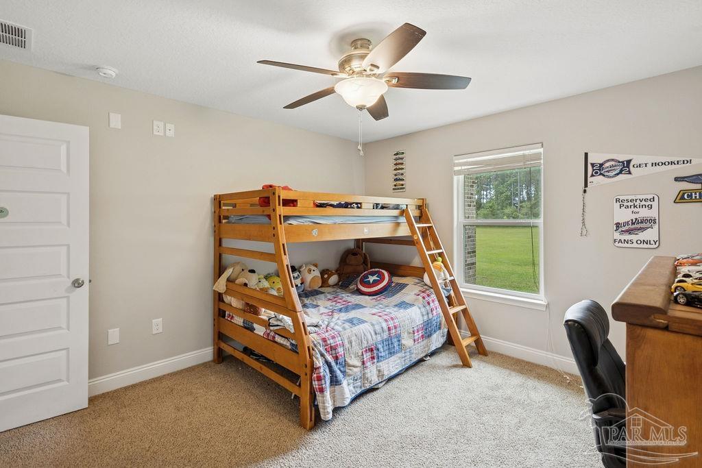 1571 Annie Penton Road Jay, FL 32565 - Photo 27 of 46 a bedroom with a bed and a desk