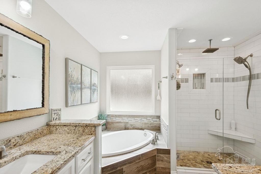 1571 Annie Penton Road Jay, FL 32565 - Photo 30 of 46 a bathroom with a granite countertop tub sink and mirror