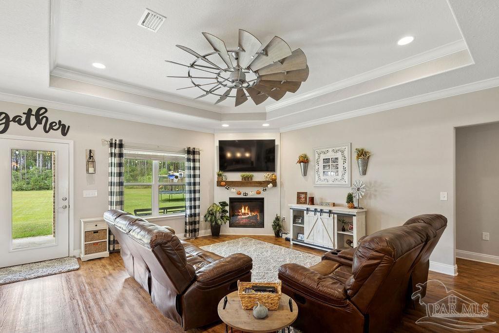 1571 Annie Penton Road Jay, FL 32565 - Photo 3 of 46 a living room with furniture a fireplace a flat screen tv and a large window