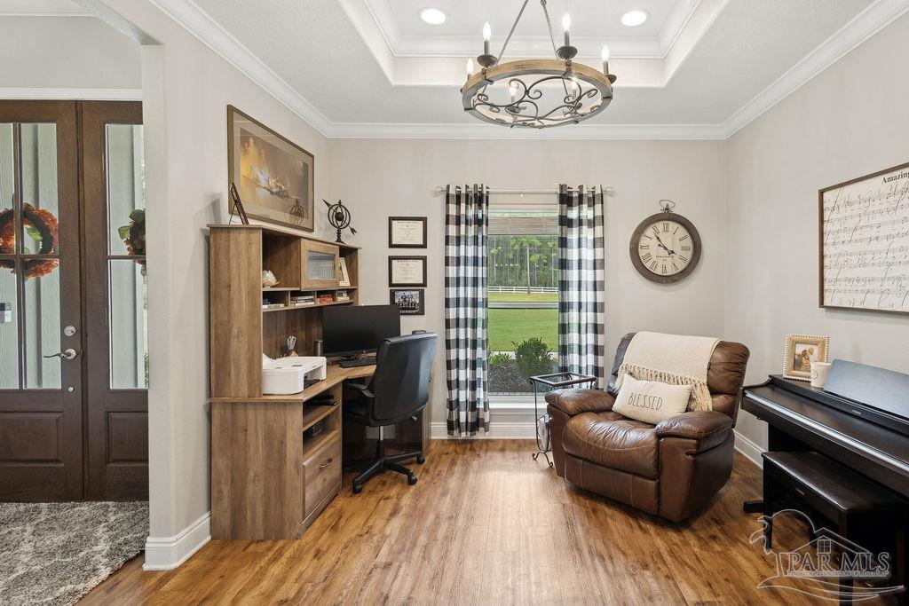 1571 Annie Penton Road Jay, FL 32565 - Photo 34 of 46 a living room with furniture a chandelier and a flat screen tv