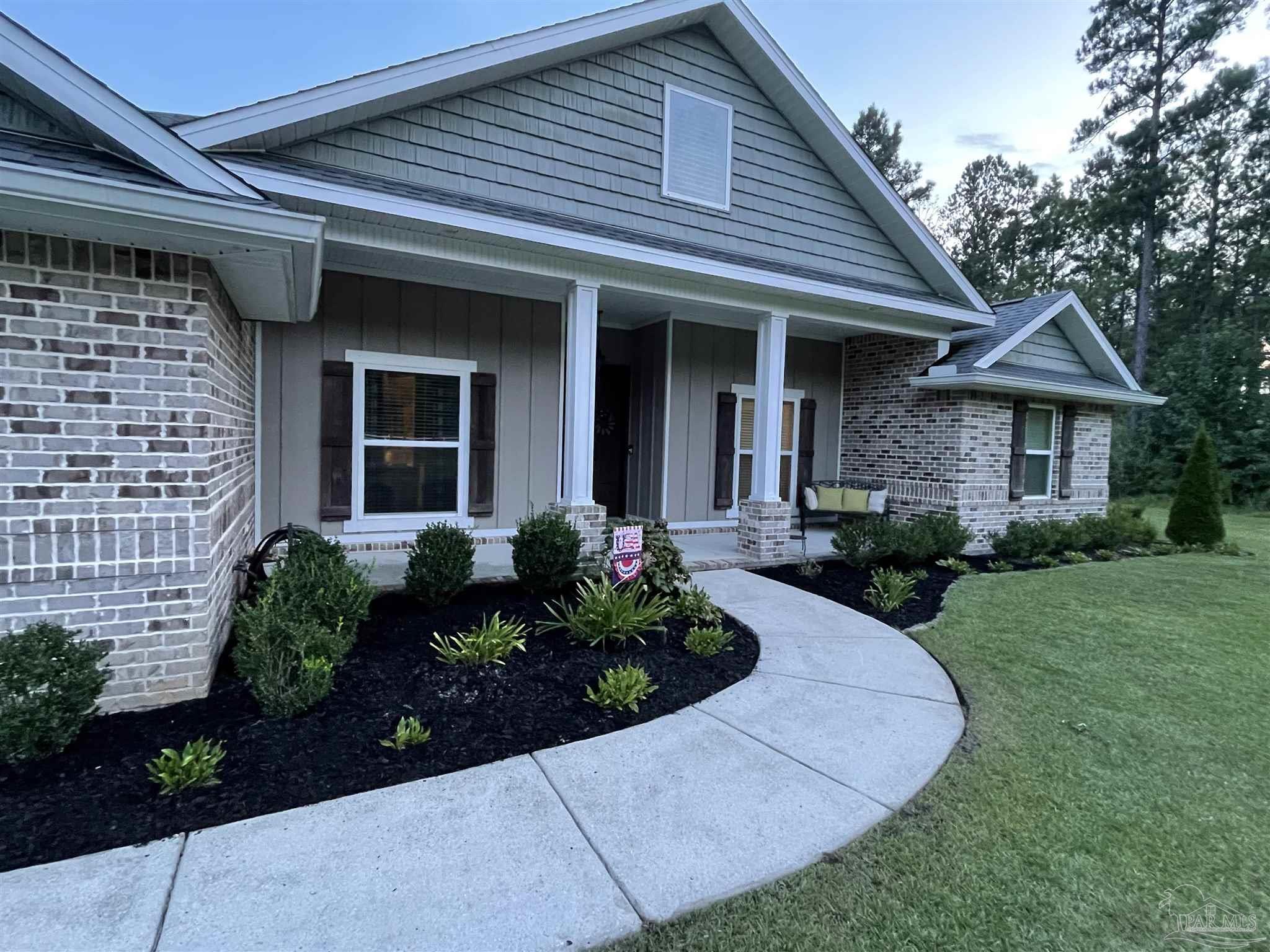 1571 Annie Penton Road Jay, FL 32565 - Photo 38 of 46 a front view of a house with garden