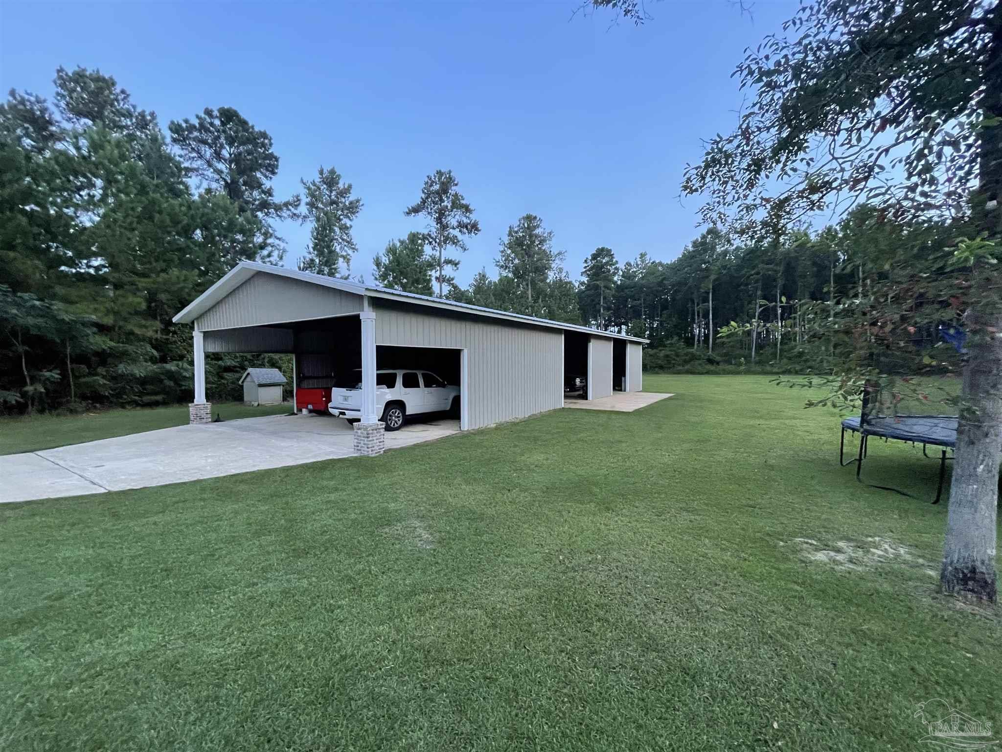 1571 Annie Penton Road Jay, FL 32565 - Photo 45 of 46 a front view of a house with garden and trees