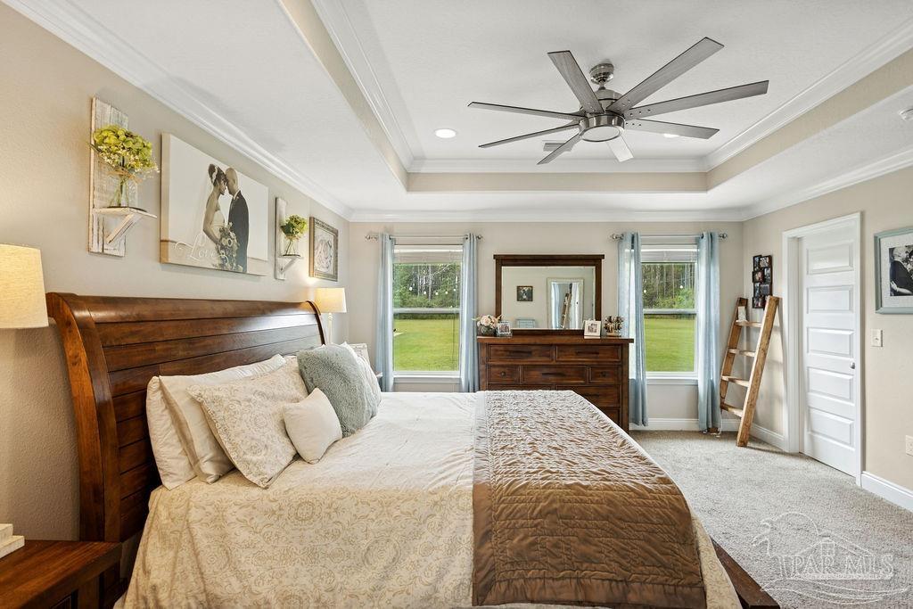 1571 Annie Penton Road Jay, FL 32565 - Photo 6 of 46 a spacious bedroom with a large bed and a chandelier