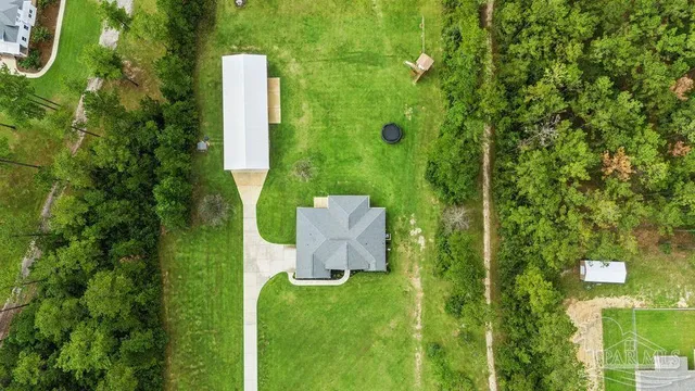 a aerial view of a house with swimming pool and big yard