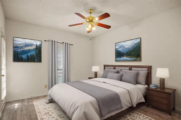 a bedroom with a large bed and a chandelier