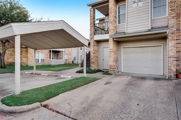 a view of a house with a yard and garage