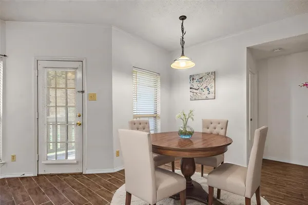 a view of a dining room with furniture and wooden floor