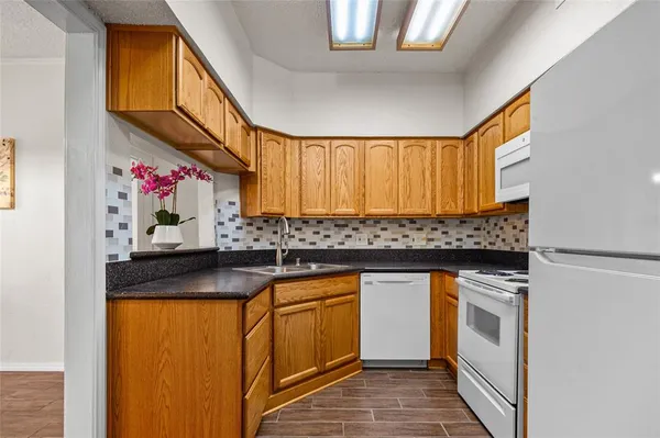a kitchen with stainless steel appliances granite countertop a sink and cabinets