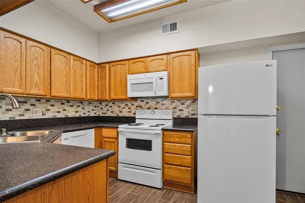 a kitchen with a white cabinets and white appliances
