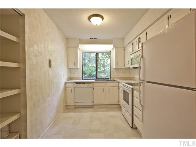 3080 Colony Road, Unit D Durham, NC 27705 - Photo 6 of 12 a kitchen with a refrigerator and a sink