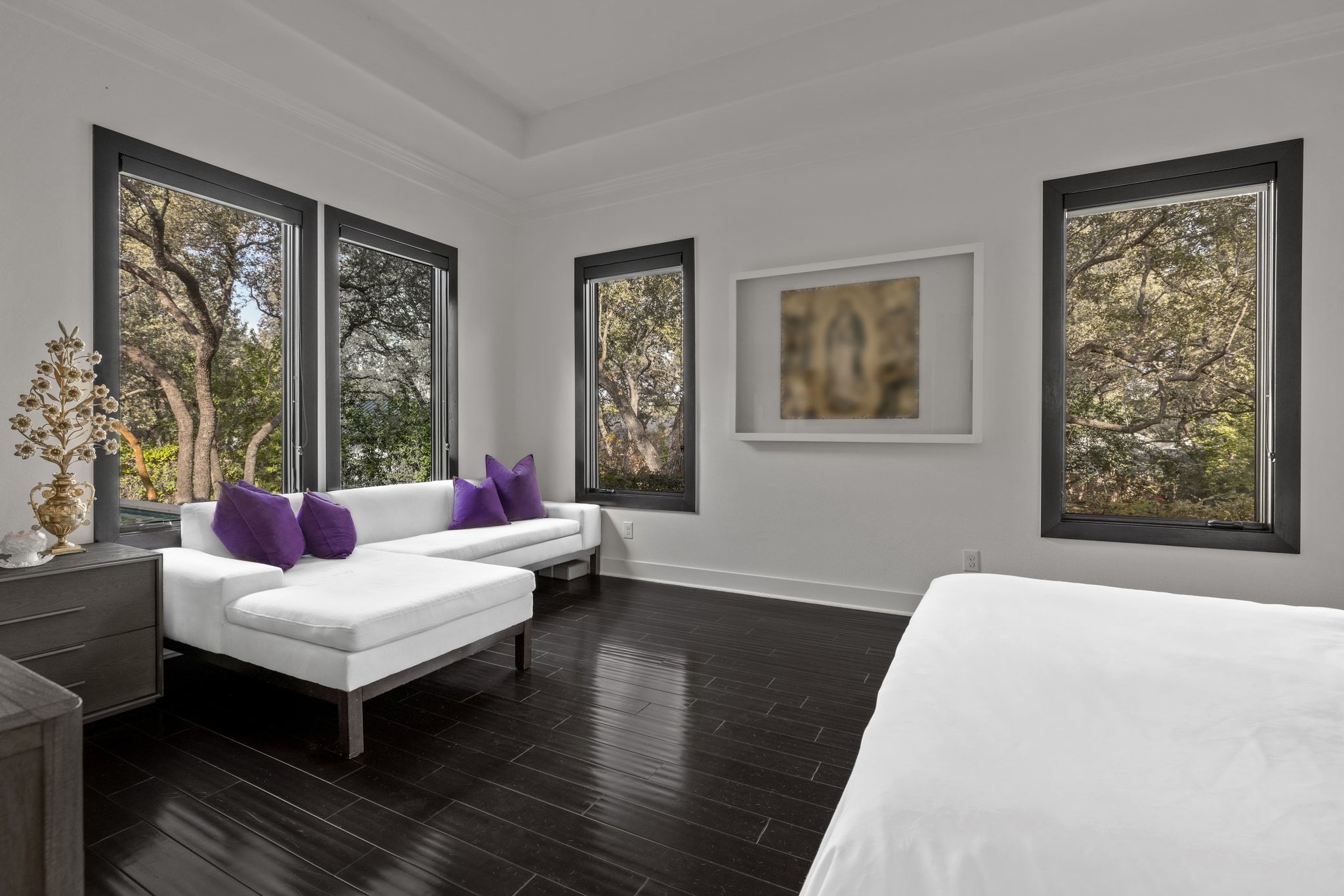 4720 Rockcliff Road, Unit 1 Austin, TX 78746 - Photo 22 of 39 Rich hardwood floors complement this spacious bedroom, offering scenic outdoor views.